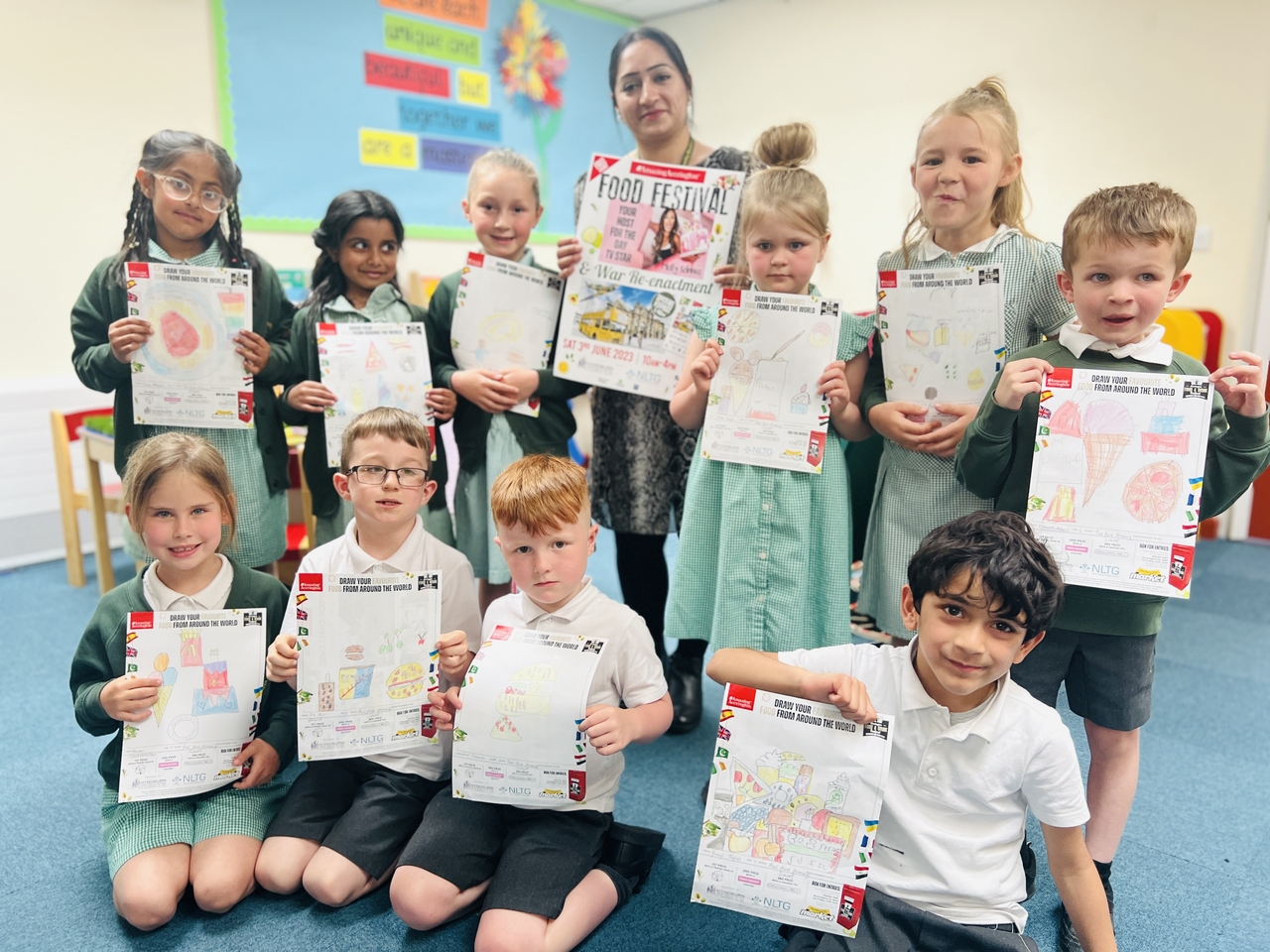 STUDENTS FROM PEEL PARK PRIMARY SCHOOL WITH THEIR ENTRIES FOR THE AMAZING ACCRINGTON DRAW YOUR FAVOURITE FOOD FROM AROUND THE WORLD COMPETITION