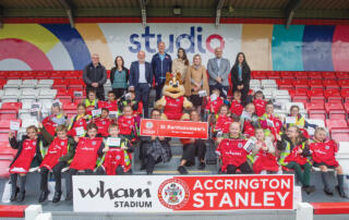 ACCRINGTON STANLEY MD DAVID BURGESS, LOUISE DANIELS AND IVOR LEFTON FROM TASKERS OF ACCRINGTON, ACCRINGTON STANLEY ASSISTANT MANAGER JIMMY BELL, MORAG DAVIS FROM ACCRINGTON AND ROSSENDALE COLLEGE, SARA BRITCLIFFE MP FOR HYNDBURN AND HASLINGDEN, GARETH LINDSAY AND EVIE CRAWSHAW FROM NORTH LANCS TRAINING GROUP